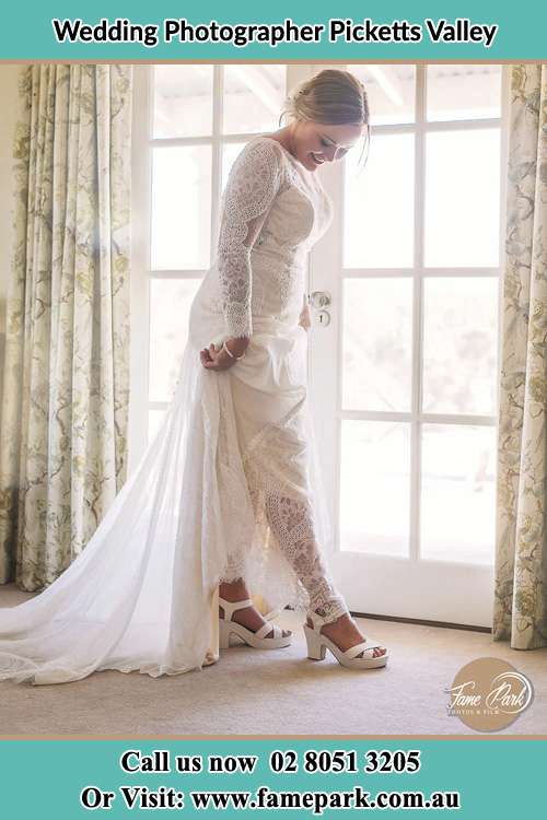 Photo of the Bride looking at her shoes Picketts Valley NSW 2251