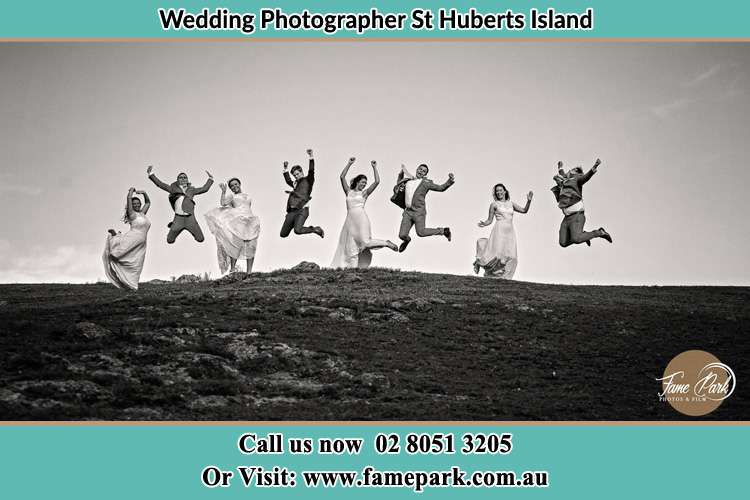 Jump shot photo of the Groom and the Bride with the entourage St Huberts Island NSW 2257