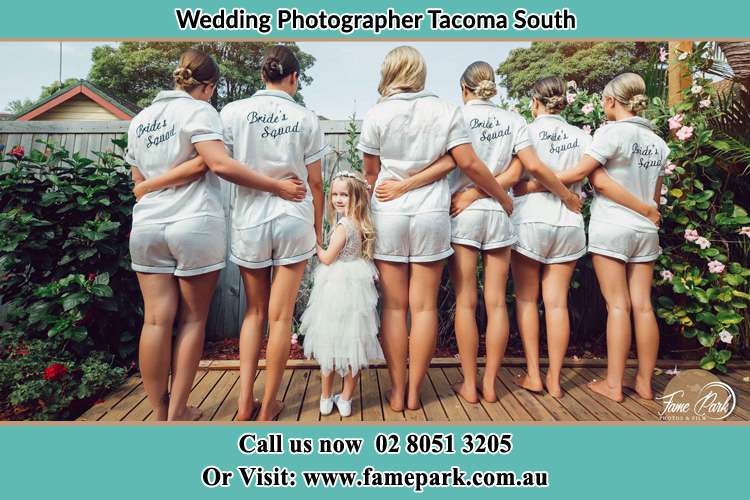 Behind photo of the Bride and the bridesmaids with the flower girl looking back Tacoma South NSW 2259