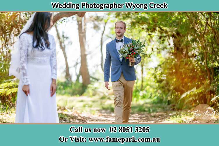 Photo of the Groom bringing flower to the Bride Wyong Creek NSW 2259